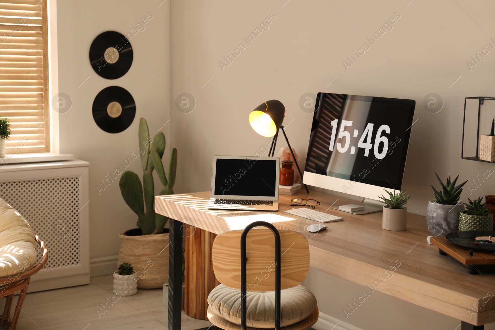 Photo of Room interior with comfortable workplace. Modern computer and laptop on wooden desk