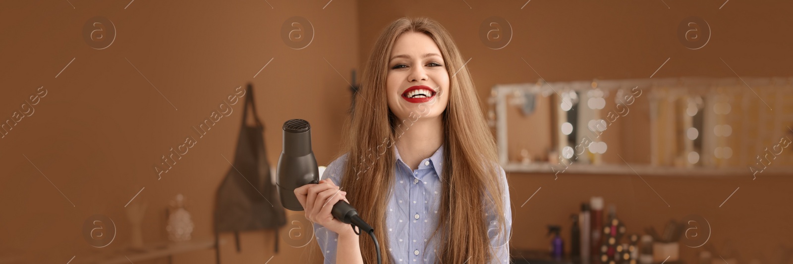 Image of Professional hairdresser with blow dryer in beauty salon. Banner design