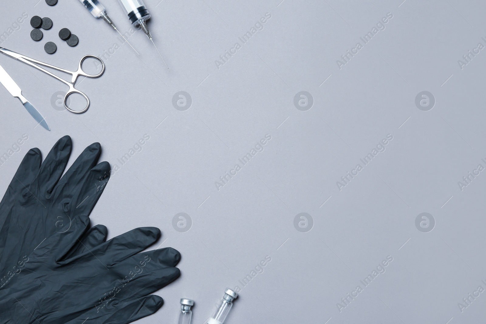 Photo of Flat lay composition with medical gloves on color background. Space for text