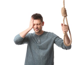 Photo of Depressed man with rope noose on white background