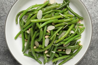 Photo of Bowl of tasty salad with green beans on grey table, top view