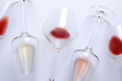 Different glasses with wine on white background, top view