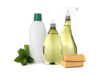 Photo of Bottles of cleaning product, sponges and green leaves isolated on white