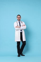 Photo of Full length portrait of smiling doctor on light blue background