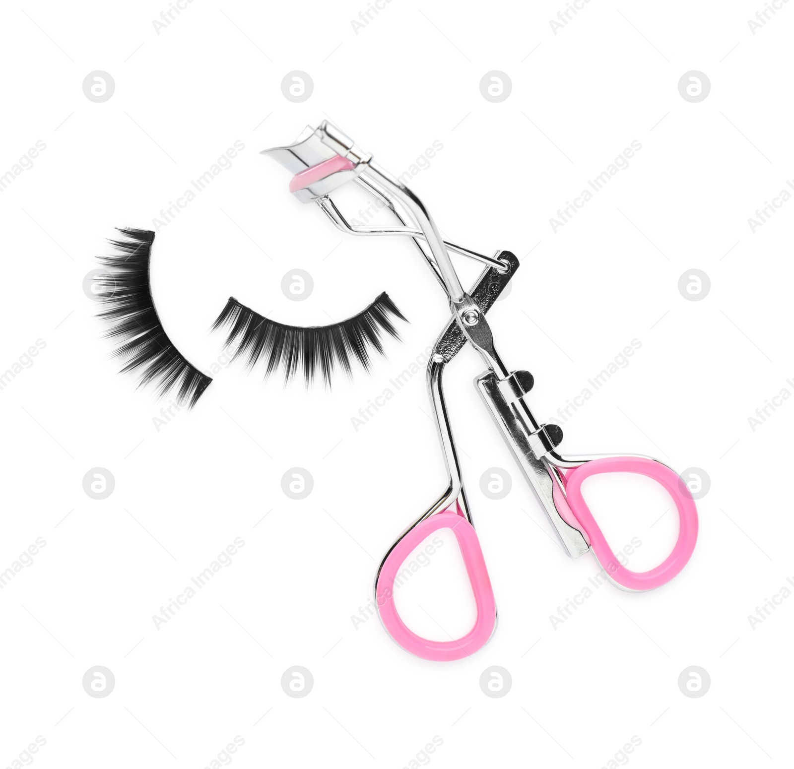 Photo of False eyelashes and curler on white background, top view