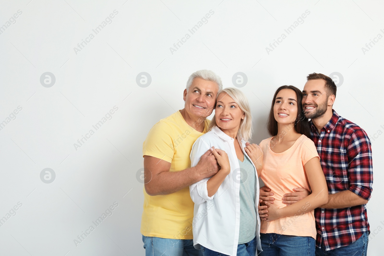 Photo of Portrait of happy family on white background. Space for text