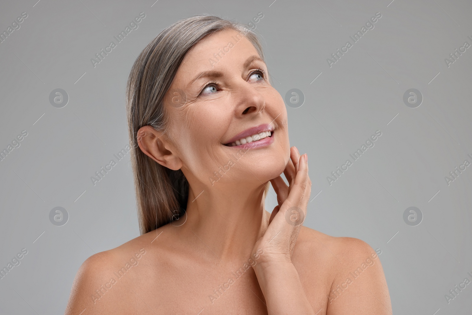 Photo of Beautiful woman with healthy skin on grey background