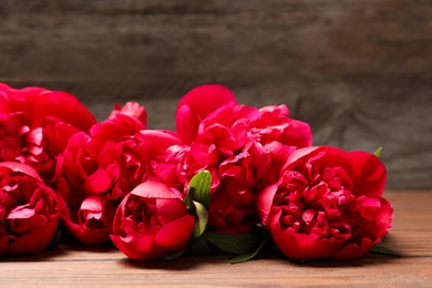 Beautiful blooming peony flowers on wooden table