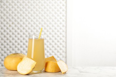 Photo of Freshly made turnip juice on white marble table, space for text