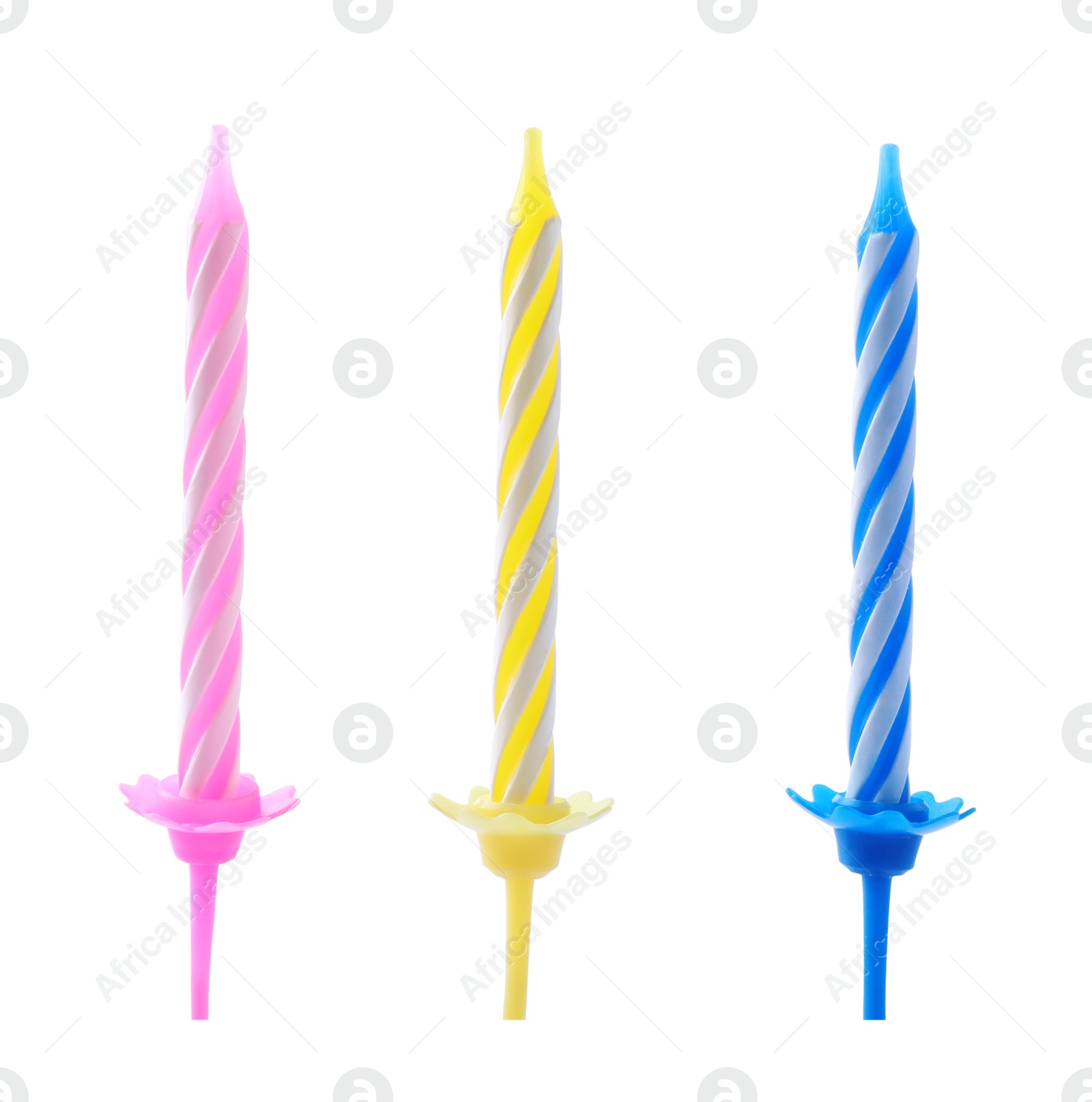 Photo of Colorful striped birthday candles in holders isolated on white