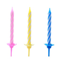 Photo of Colorful striped birthday candles in holders isolated on white