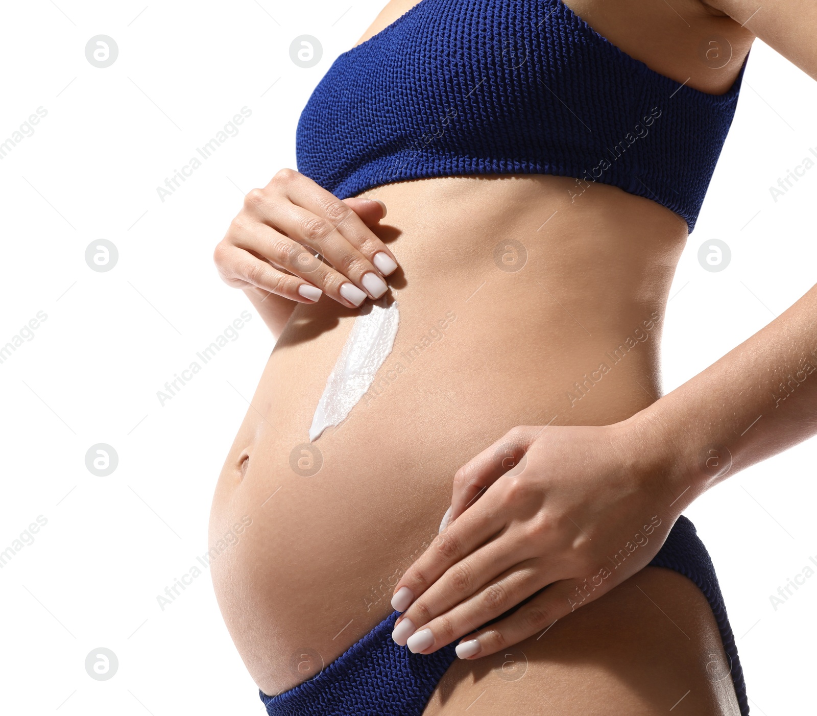 Photo of Pregnant woman applying sun protection cream on her belly against white background, closeup