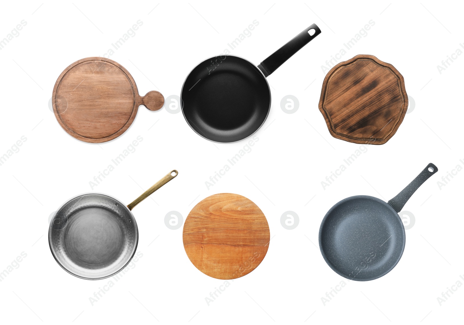 Image of Set with pans and wooden cutting boards on white background, top view