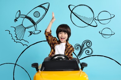 Cute little boy driving toy car and drawing of space on light blue background