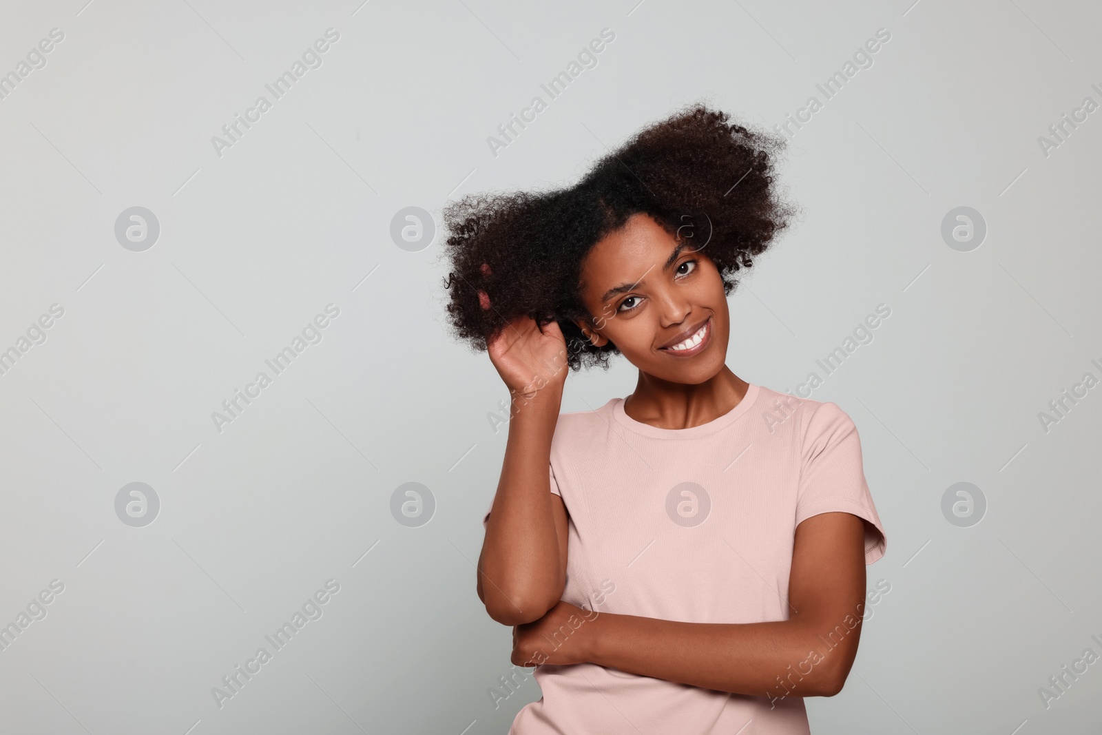 Photo of Portrait of smiling African American woman on light grey background. Space for text