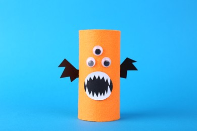 Photo of Spooky monster on light blue background. Handmade Halloween decoration