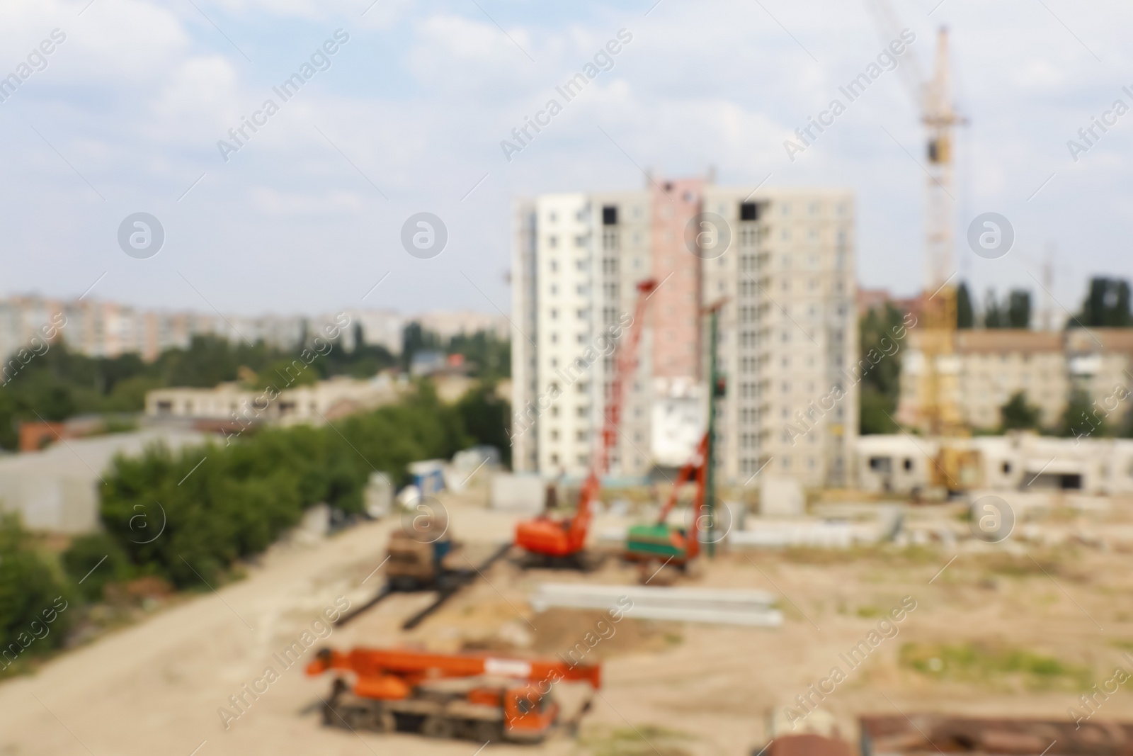 Photo of Blurred view of construction site with heavy machinery near unfinished building