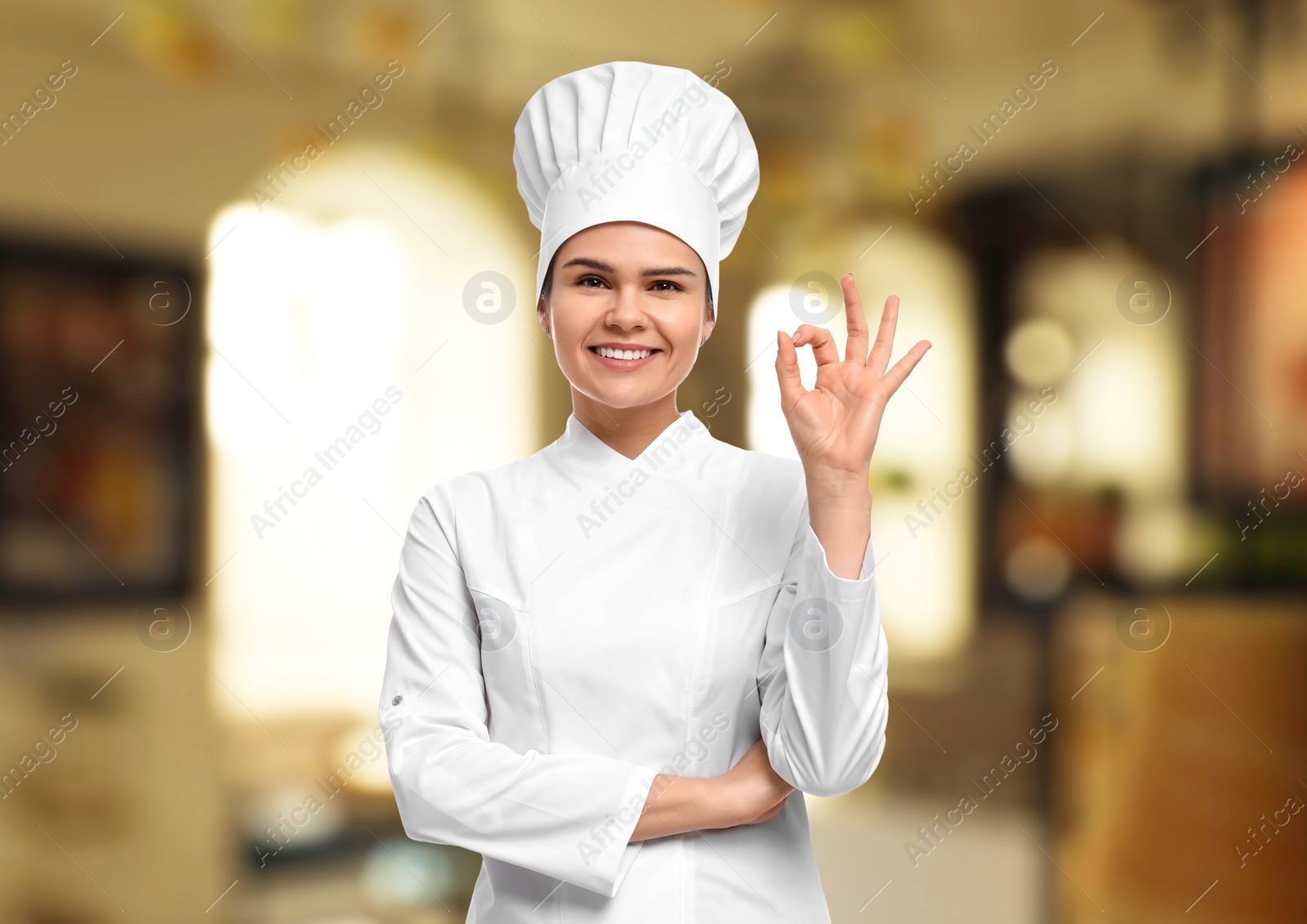 Image of Smiling chef showing ok gesture in restaurant