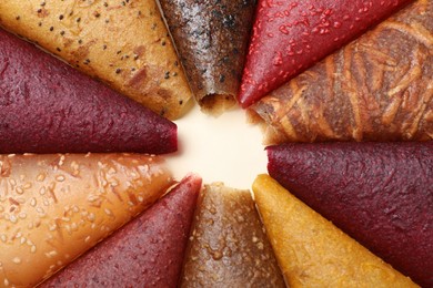 Photo of Delicious fruit leather rolls on beige background, closeup