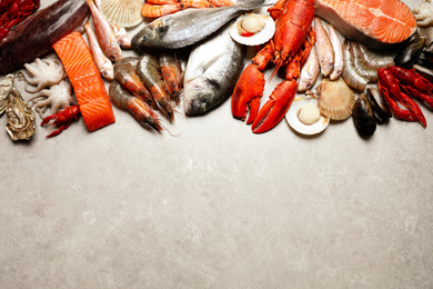 Photo of Fresh fish and seafood on marble table, flat lay. Space for text