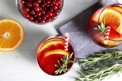 Photo of Flat lay composition with cranberry and rosemary cocktail on light table