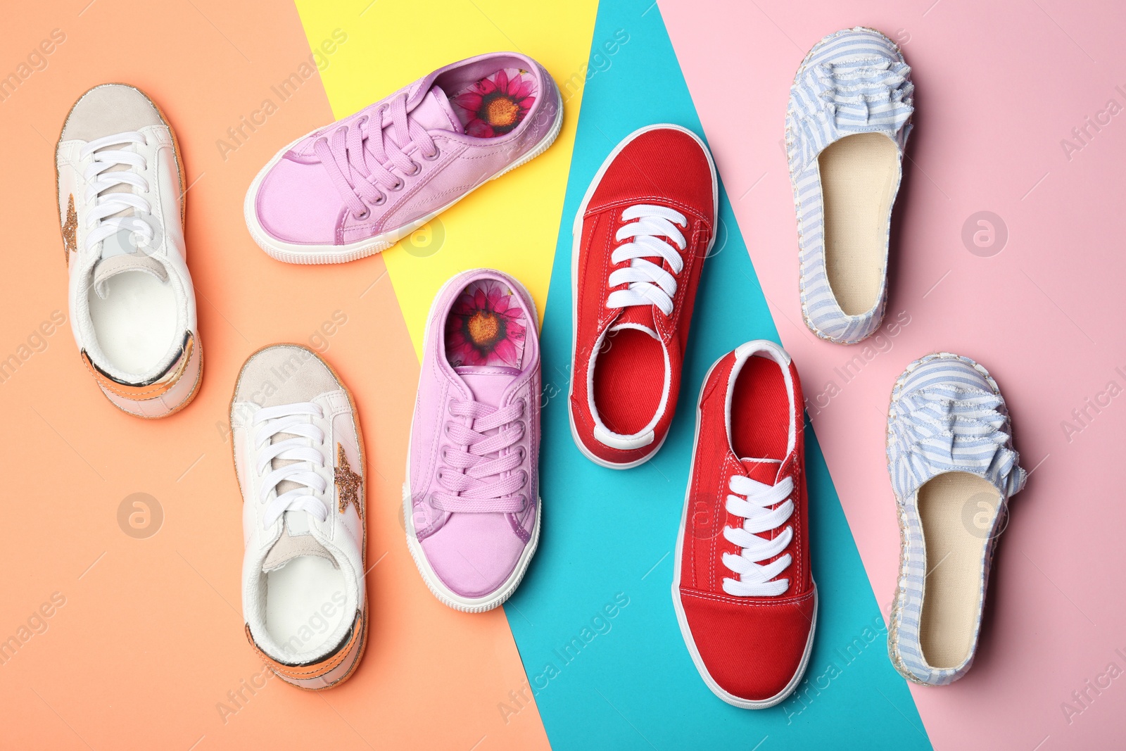 Photo of Flat lay composition with stylish new shoes on color background