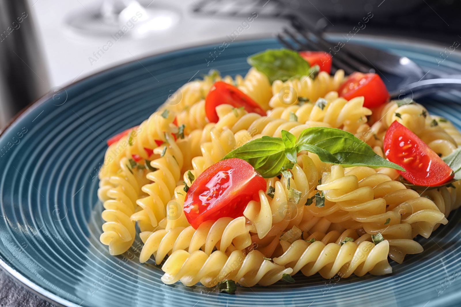 Photo of Delicious pasta with tomatoes and basil, closeup