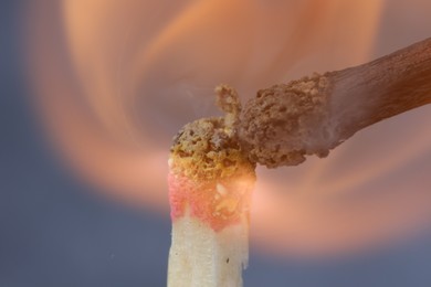 Photo of Lighting up matchstick on grey background, macro view