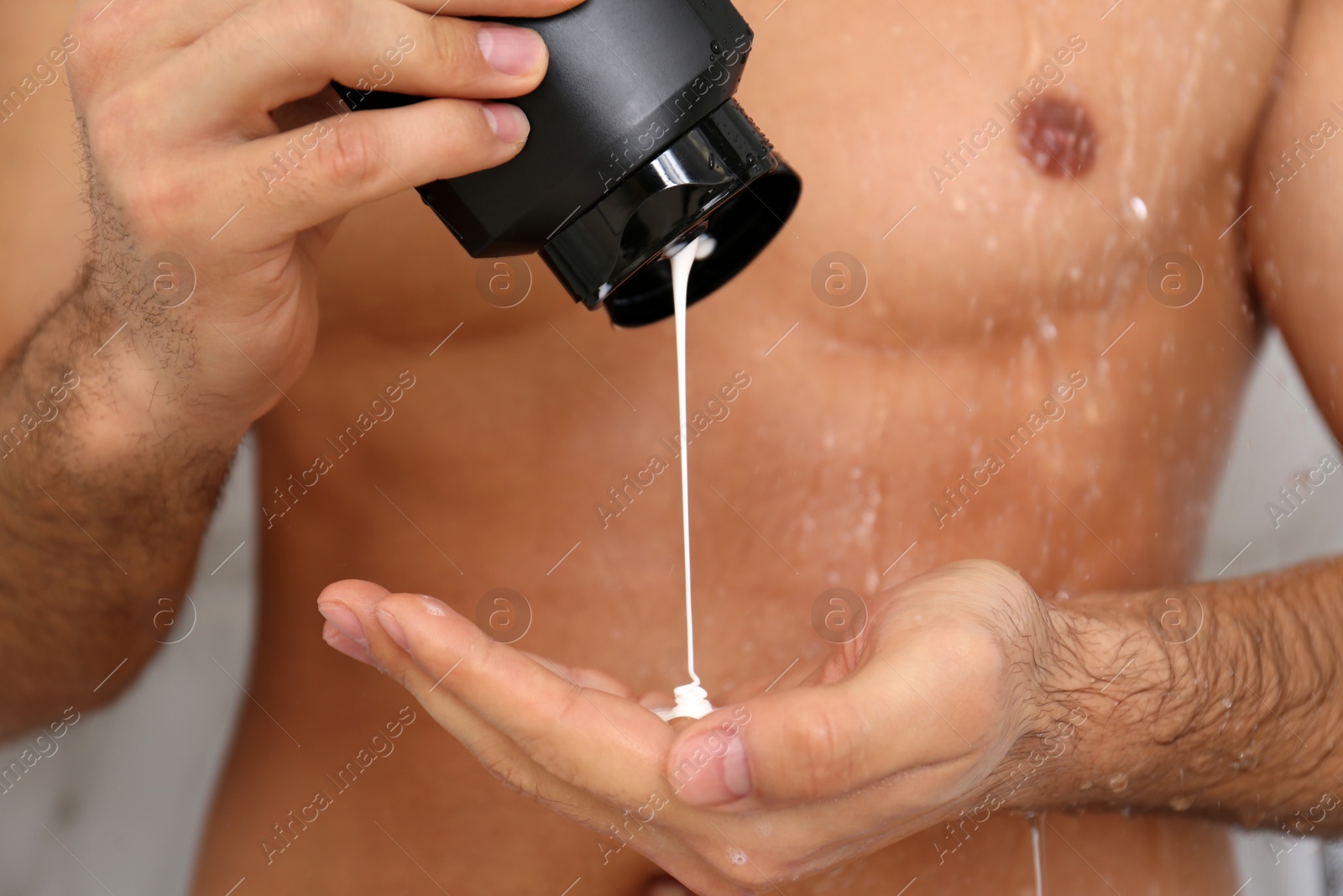 Photo of Man applying gel in shower at home, closeup