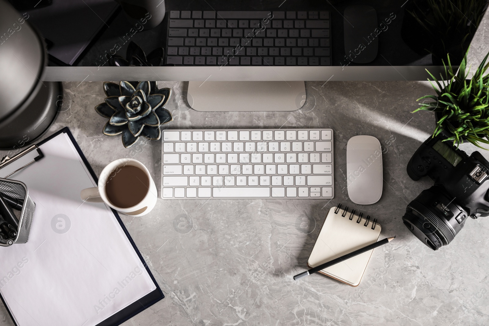 Photo of Designer's workplace with modern computer and camera, flat lay