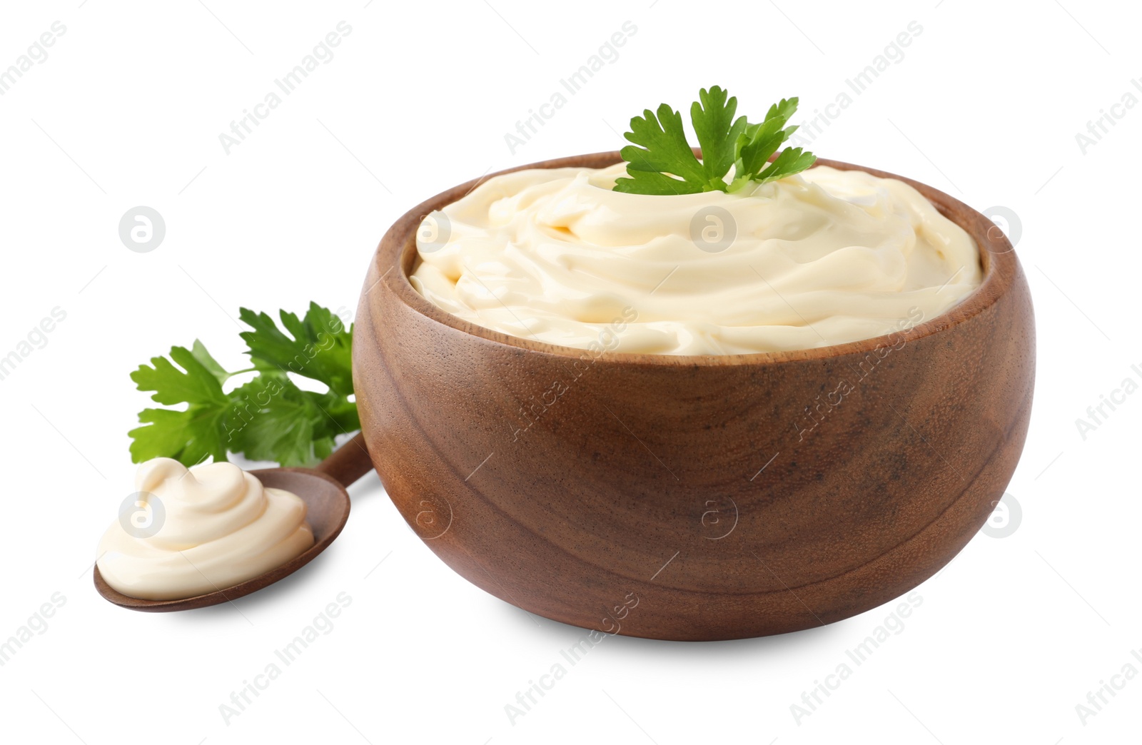 Photo of Spoon and bowl of delicious mayonnaise with parsley on white background