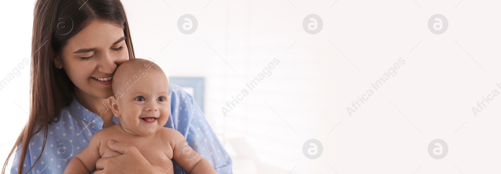 Photo of Happy young mother with her cute baby at home