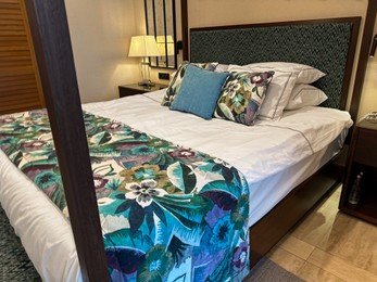 Large bed with pillows and linens in comfortable hotel room