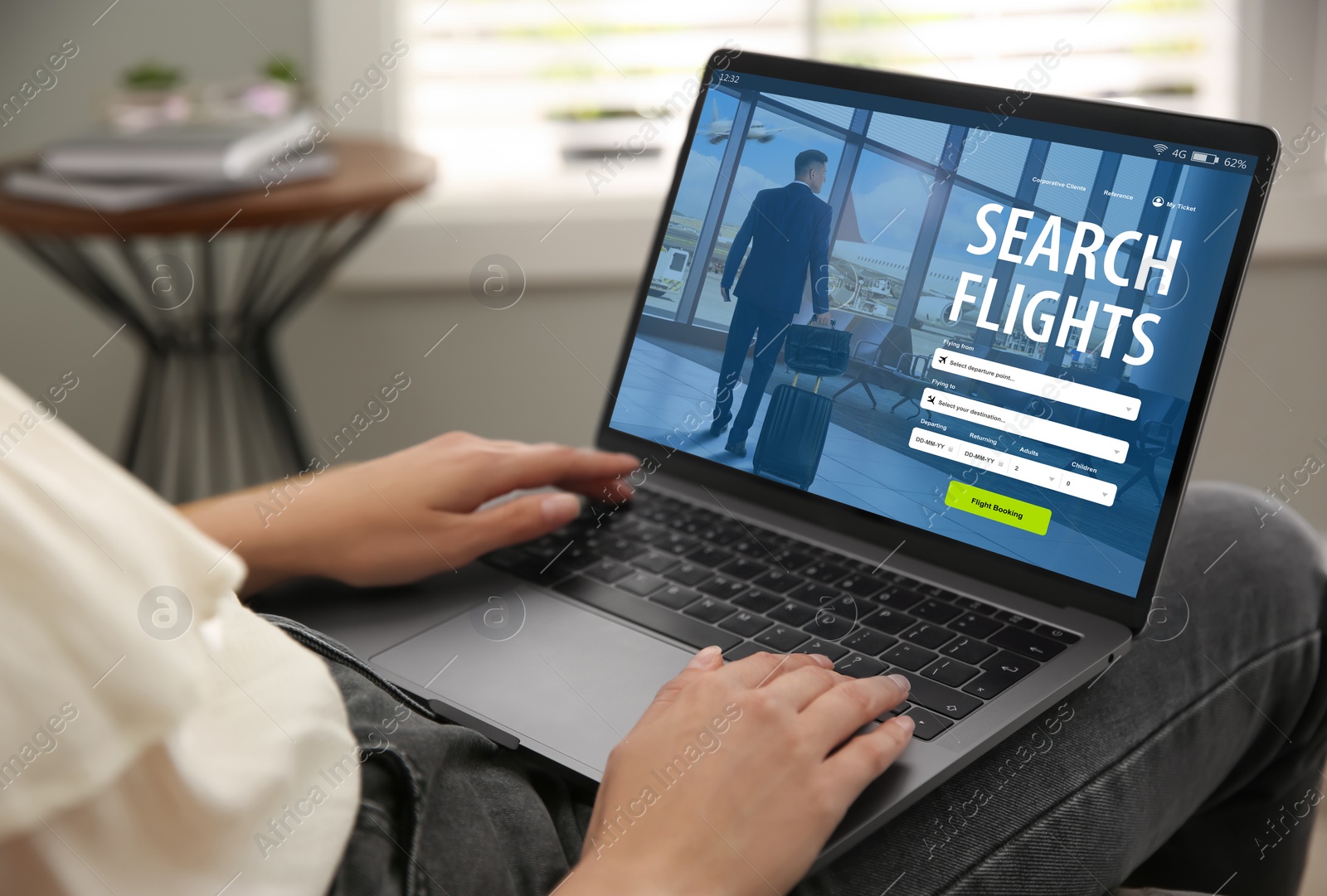 Image of Woman using laptop to book flight at home, closeup