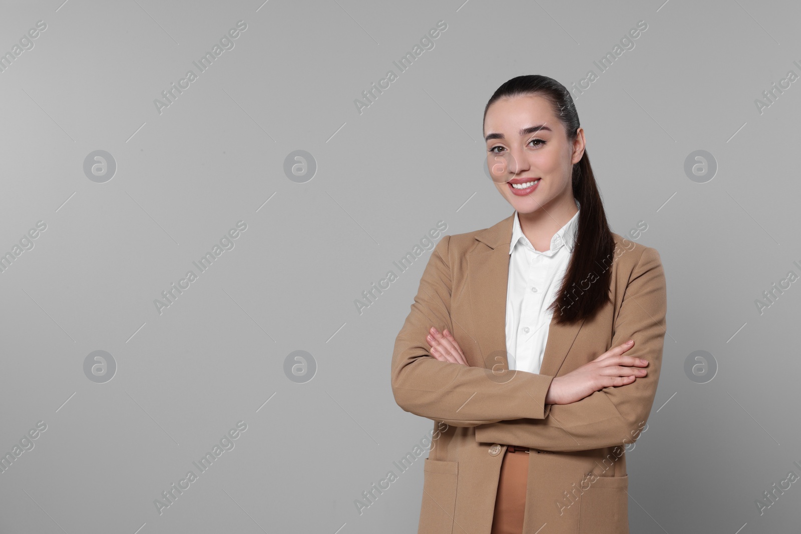 Photo of Happy real estate agent on grey background. Space for text