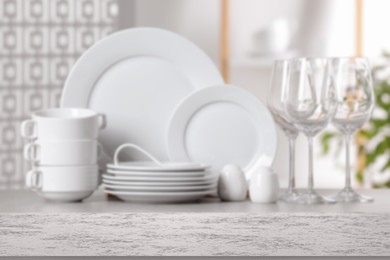 Set of clean dishware, focus on empty stone table