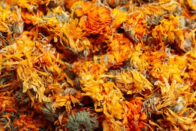 Pile of dry calendula flowers as background, closeup