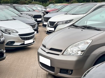 View of many different cars in parking lot