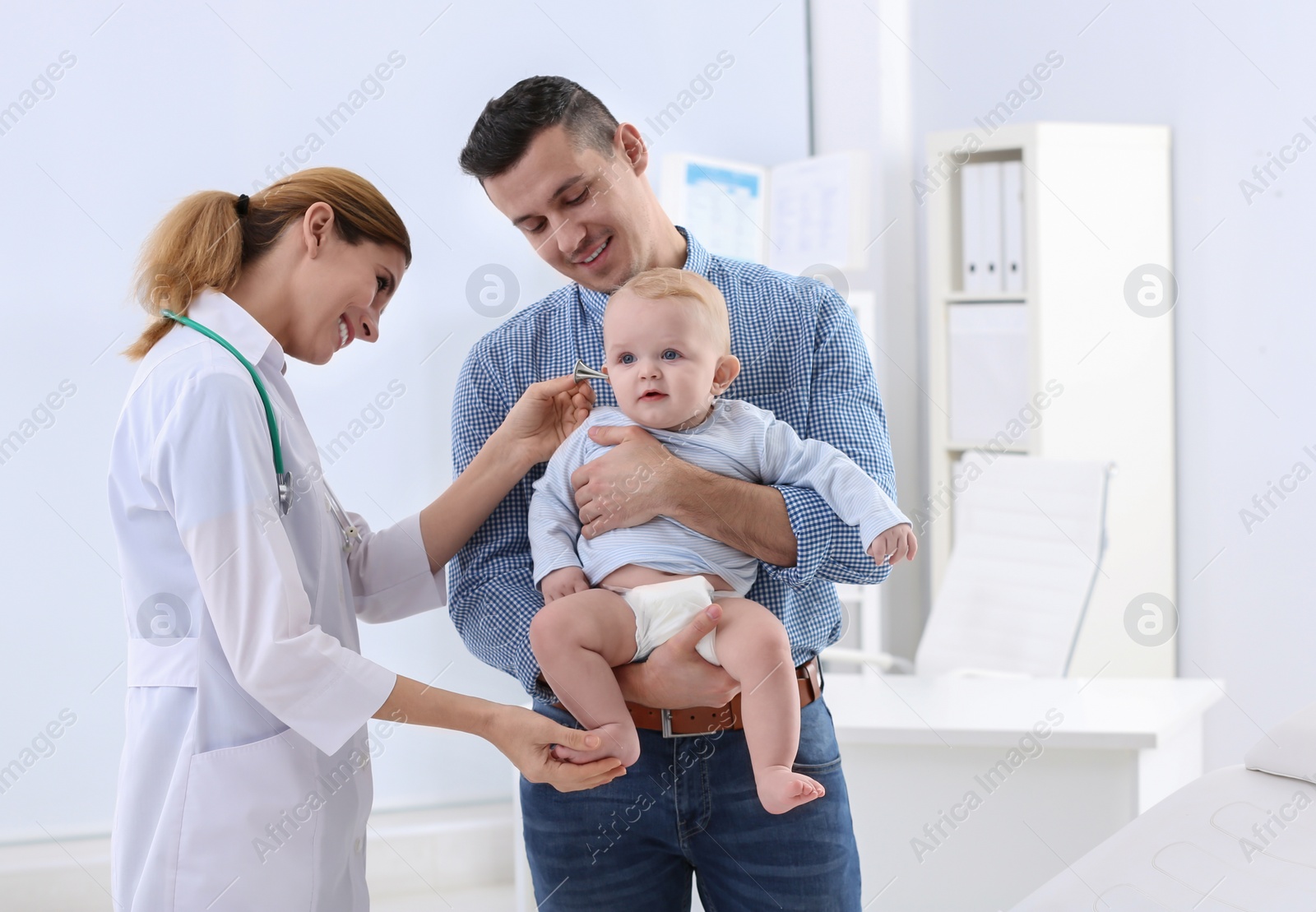 Photo of Man with his baby visiting children's doctor in hospital