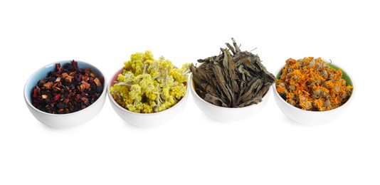 Photo of Many different dry herbs and flowers in bowls isolated on white