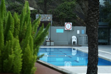 Outdoor swimming pool and different green plants at resort