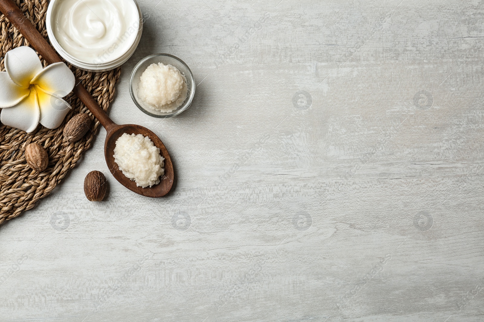 Photo of Flat lay composition with Shea butter, nuts and space for text on light background