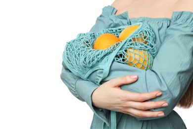 Photo of Woman with string bag of fresh lemons on white background, closeup