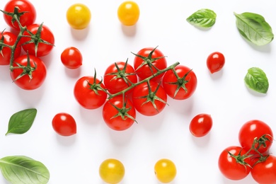 Composition with ripe cherry tomatoes and basil leaves on white background, top view