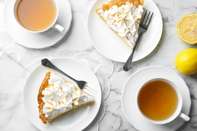 Delicious lemon meringue pie served on white marble table, flat lay