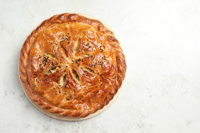 Photo of Tasty homemade pie with filling on light table, top view. Space for text