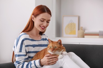 Happy woman with her cute cat at home