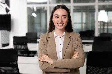 Happy female real estate agent in office