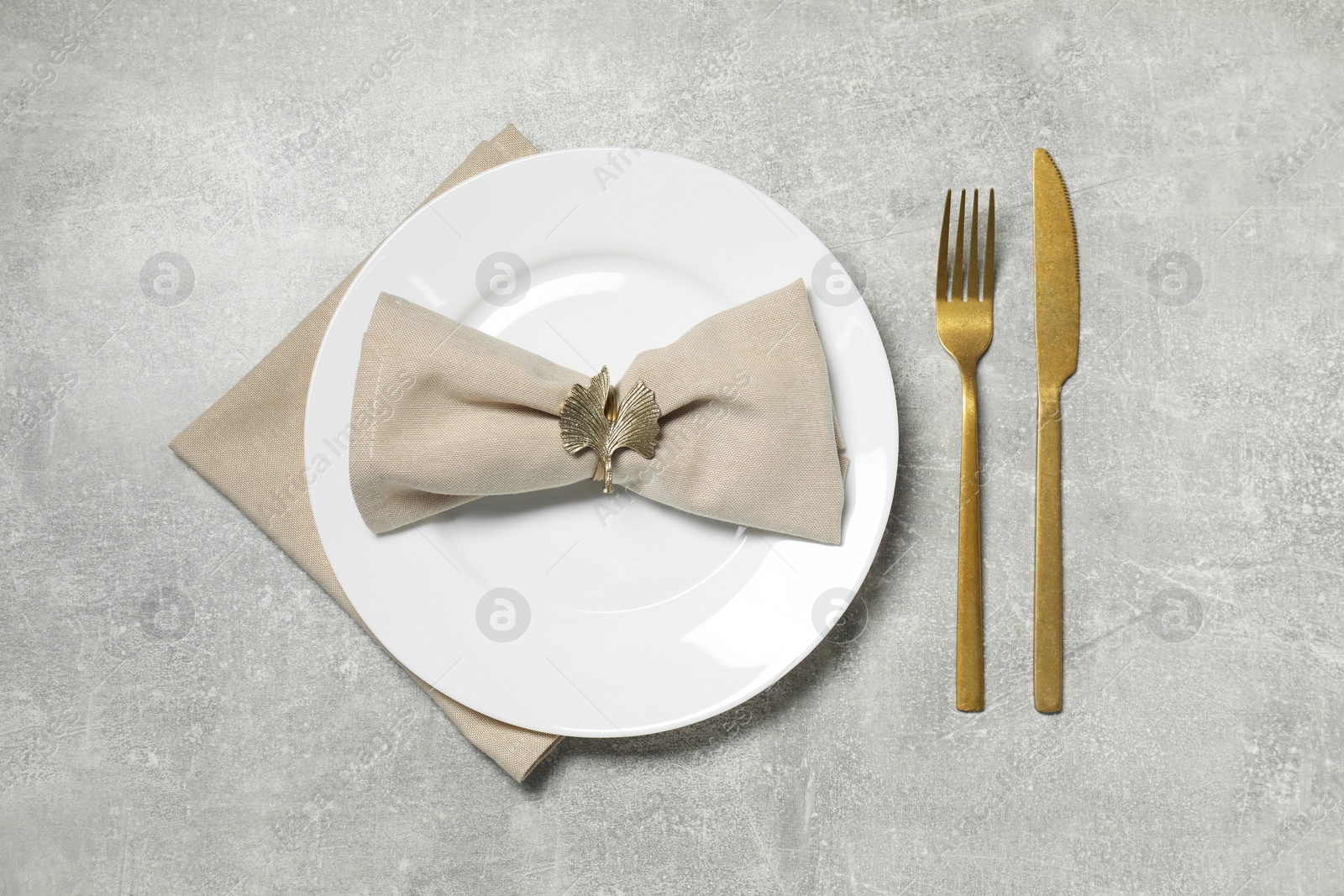 Photo of Stylish setting with elegant cutlery on grey table, flat lay