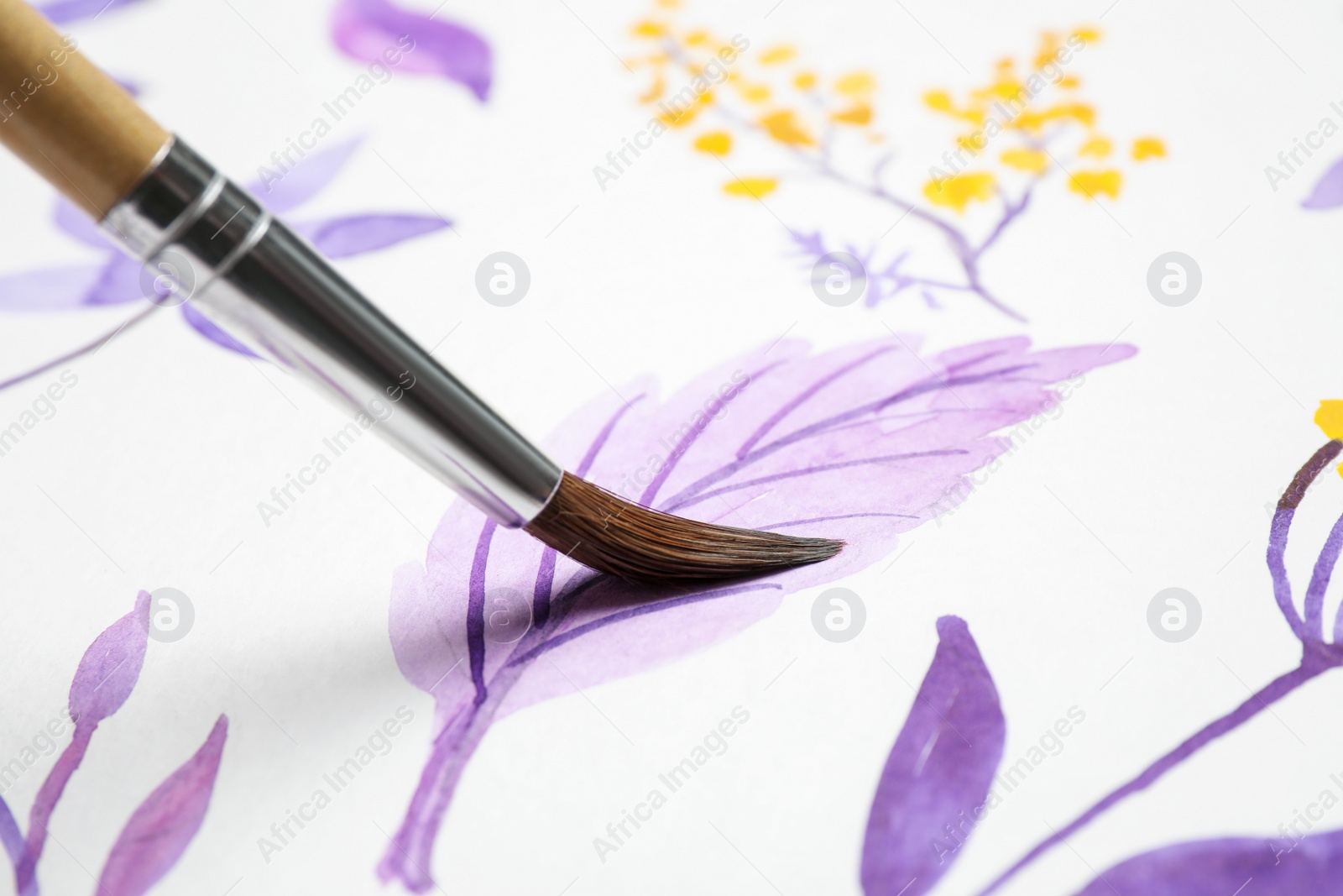 Photo of Painting leaf with watercolor on white paper, closeup